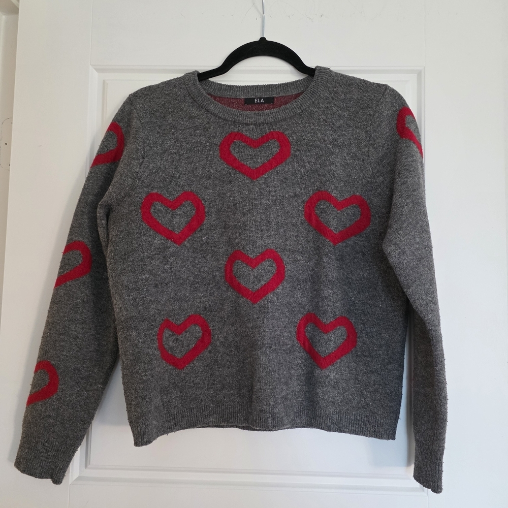 Grey crewneck sweater featuring a red heart intarsia pattern.
